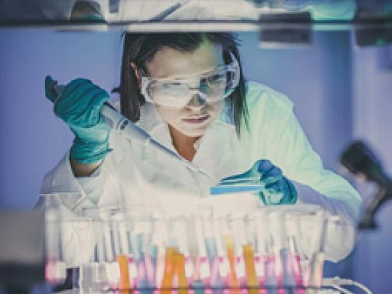 Researcher Filing Tubes and wearing goggles